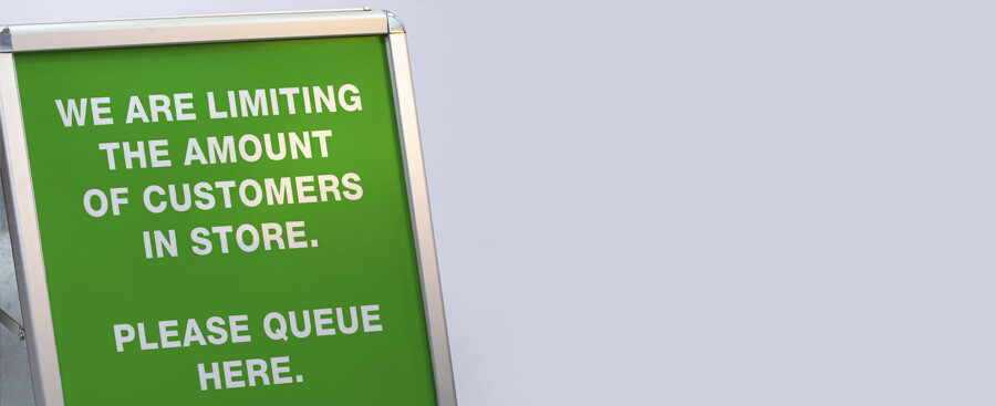 coronavirus limited numbers a-frame sign for social distancing in queues