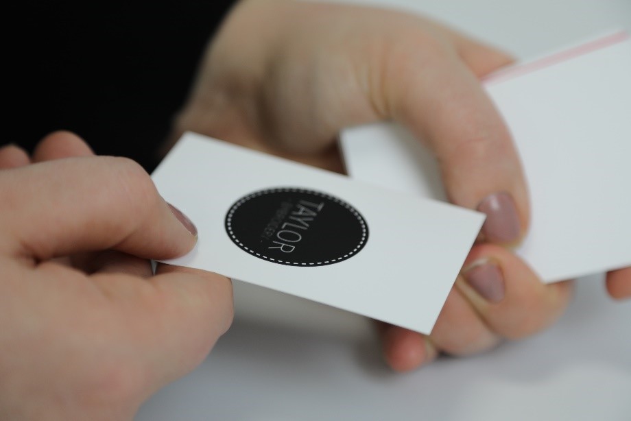 matt lamination business card with a white background and black logo