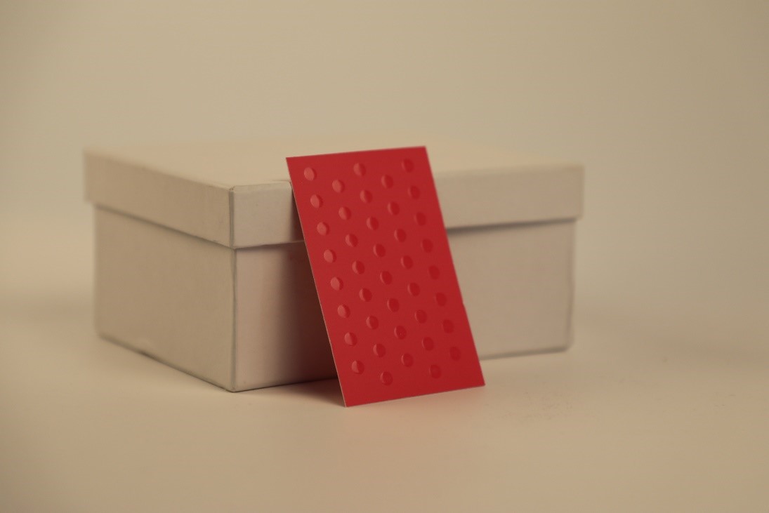 pink business card with raised spot UV circles