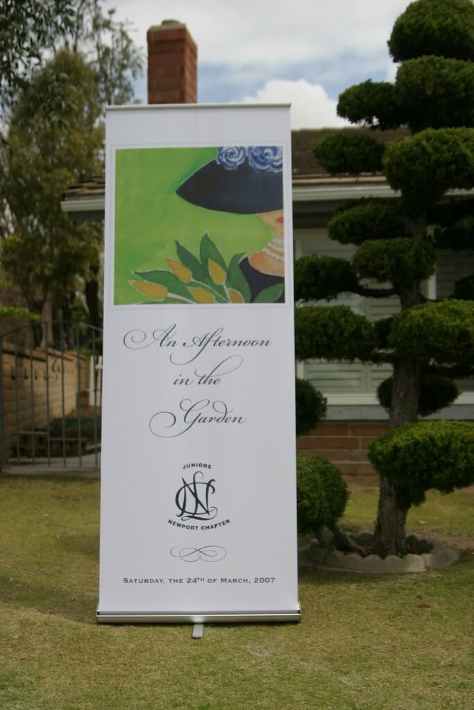 garden party roller banner advertising an outdoor event