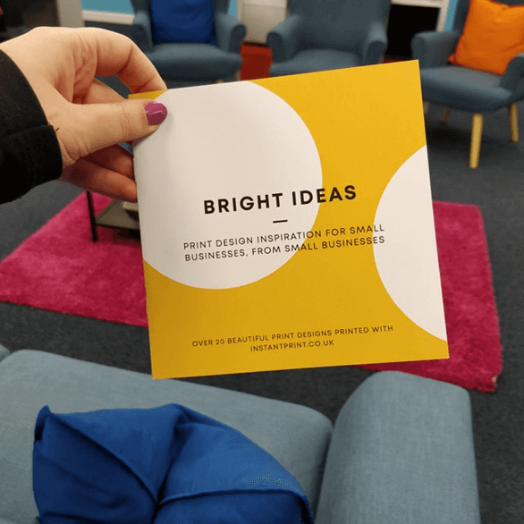 coffee table book featuring print designs in a colourful office